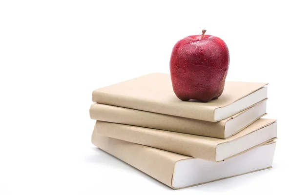 Fresh apple on stack of old books, isolated on white — Stock Photo, Image