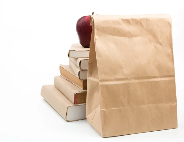 Fresh apple on stack of old books, isolated on white — Stock Photo, Image