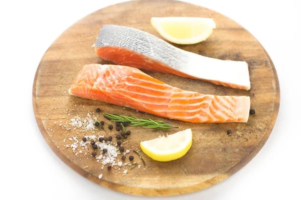 Fresh salmon with spices on wood over white background — Stock Photo, Image