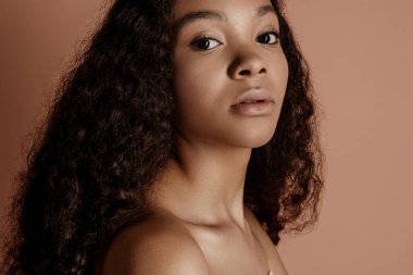 Close up portrait of sensual young female in hat. Clean skin. Healthy care. Portrait of beautiful african american in hat isolated. Studio shoot. Portrait of beauty girl model with natural make up