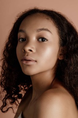 Close up portrait of sensual young female in hat. Clean skin. Healthy care. Portrait of beautiful african american in hat isolated. Studio shoot. Portrait of beauty girl model with natural make up