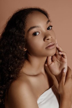 Close up portrait of sensual young female in hat. Clean skin. Healthy care. Portrait of beautiful african american in hat isolated. Studio shoot. Portrait of beauty girl model with natural make up