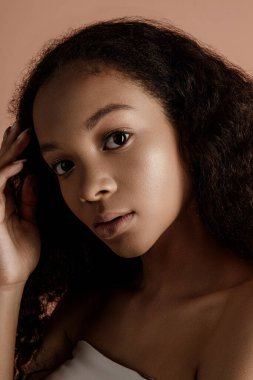Close up portrait of sensual young female in hat. Clean skin. Healthy care. Portrait of beautiful african american in hat isolated. Studio shoot. Portrait of beauty girl model with natural make up