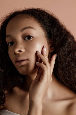 Close up portrait of sensual young female in hat. Clean skin. Healthy care. Portrait of beautiful african american in hat isolated. Studio shoot. Portrait of beauty girl model with natural make up