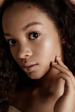 Close up portrait of sensual young female in hat. Clean skin. Healthy care. Portrait of beautiful african american in hat isolated. Studio shoot. Portrait of beauty girl model with natural make up