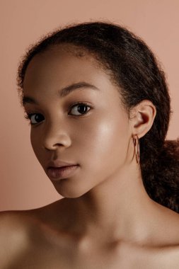 Close up portrait of sensual young female in hat. Clean skin. Healthy care. Portrait of beautiful african american in hat isolated. Studio shoot. Portrait of beauty girl model with natural make up
