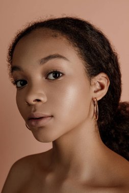Close up portrait of sensual young female in hat. Clean skin. Healthy care. Portrait of beautiful african american in hat isolated. Studio shoot. Portrait of beauty girl model with natural make up