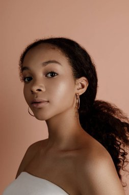 Close up portrait of sensual young female in hat. Clean skin. Healthy care. Portrait of beautiful african american in hat isolated. Studio shoot. Portrait of beauty girl model with natural make up