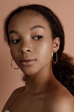 Close up portrait of sensual young female in hat. Clean skin. Healthy care. Portrait of beautiful african american in hat isolated. Studio shoot. Portrait of beauty girl model with natural make up