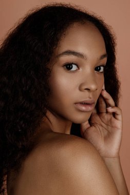 Close up portrait of sensual young female in hat. Clean skin. Healthy care. Portrait of beautiful african american in hat isolated. Studio shoot. Portrait of beauty girl model with natural make up