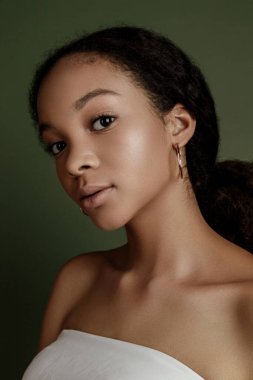 Beauty photo of young elegant African American woman with afro. Hands poses. Gentle portrait.  Fashion beauty close up portrait. Nude make-up. Studio photoshoot. Female model. Beautiful girl