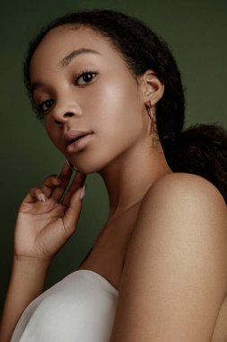 Beauty photo of young elegant African American woman with afro. Hands poses. Gentle portrait.  Fashion beauty close up portrait. Nude make-up. Studio photoshoot. Female model. Beautiful girl