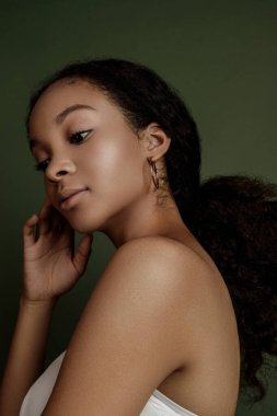 Beauty photo of young elegant African American woman with afro. Hands poses. Gentle portrait.  Fashion beauty close up portrait. Nude make-up. Studio photoshoot. Female model. Beautiful girl
