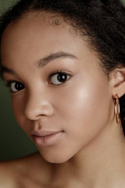 Beauty photo of young elegant African American woman with afro. Hands posing. Gentle portrait.  Fashion beauty close up portrait. Nude make-up. Studio photoshoot. Female model. Beautiful girl