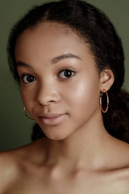 Beauty photo of young elegant African American woman with afro. Hands posing. Gentle portrait.  Fashion beauty close up portrait. Nude make-up. Studio photoshoot. Female model. Beautiful girl