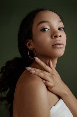 Beauty photo of young elegant African American woman with afro. Hands poses. Gentle portrait.  Fashion beauty close up portrait. Nude make-up. Studio photoshoot. Female model. Beautiful girl