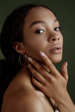 Beauty photo of young elegant African American woman with afro. Hands poses. Gentle portrait.  Fashion beauty close up portrait. Nude make-up. Studio photoshoot. Female model. Beautiful girl
