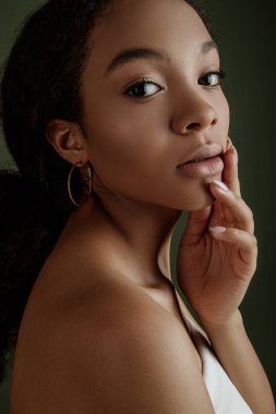 Beauty photo of young elegant African American woman with afro. Hands poses. Gentle portrait.  Fashion beauty close up portrait. Nude make-up. Studio photoshoot. Female model. Beautiful girl