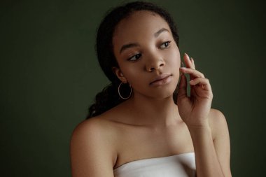 Beauty photo of young elegant African American woman with afro. Hands poses. Gentle portrait.  Fashion beauty close up portrait. Nude make-up. Studio photoshoot. Female model. Beautiful girl