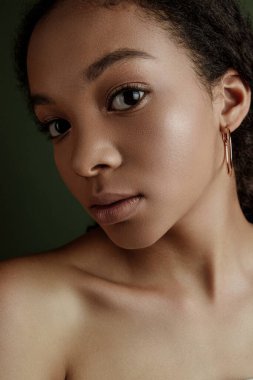 Beauty photo of young elegant African American woman with afro. Hands posing. Gentle portrait.  Fashion beauty close up portrait. Nude make-up. Studio photoshoot. Female model. Beautiful girl