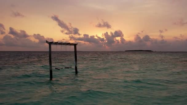 Drone shot of Maldives sunset and swing in ocean, panoramic sky and island — Stockvideo