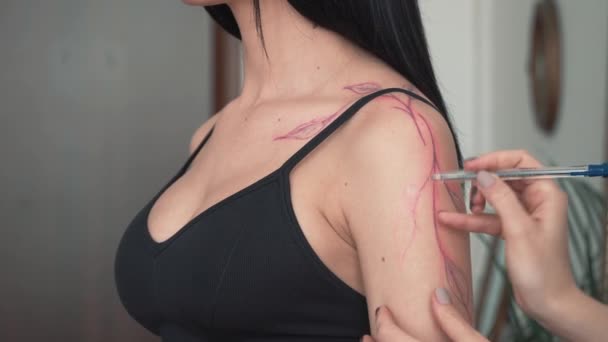Una técnica de tatuaje a mano alzada se dibuja en la mano de los clientes, bosquejo directamente en la piel con marcadores en lugar de transferir una plantilla, en tiempo real — Vídeos de Stock