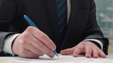 İş adamı not alıyor ya da kontrat imzalıyor, kalem ve belge, resmi ceketli adam. Elini kapat..