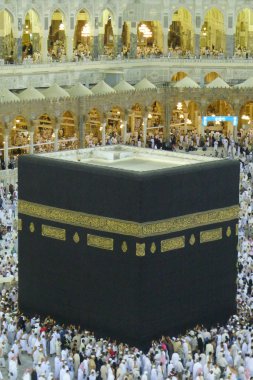A close up view of Muslim pilgrims circumambulate the Kaaba from ground floor of Haram Mosque, Mecca. clipart