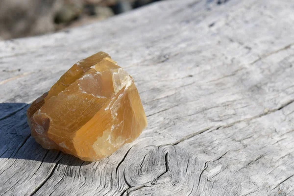 Uma Imagem Único Espécime Cristal Calcita Mel Descansando Pedaço Madeira — Fotografia de Stock