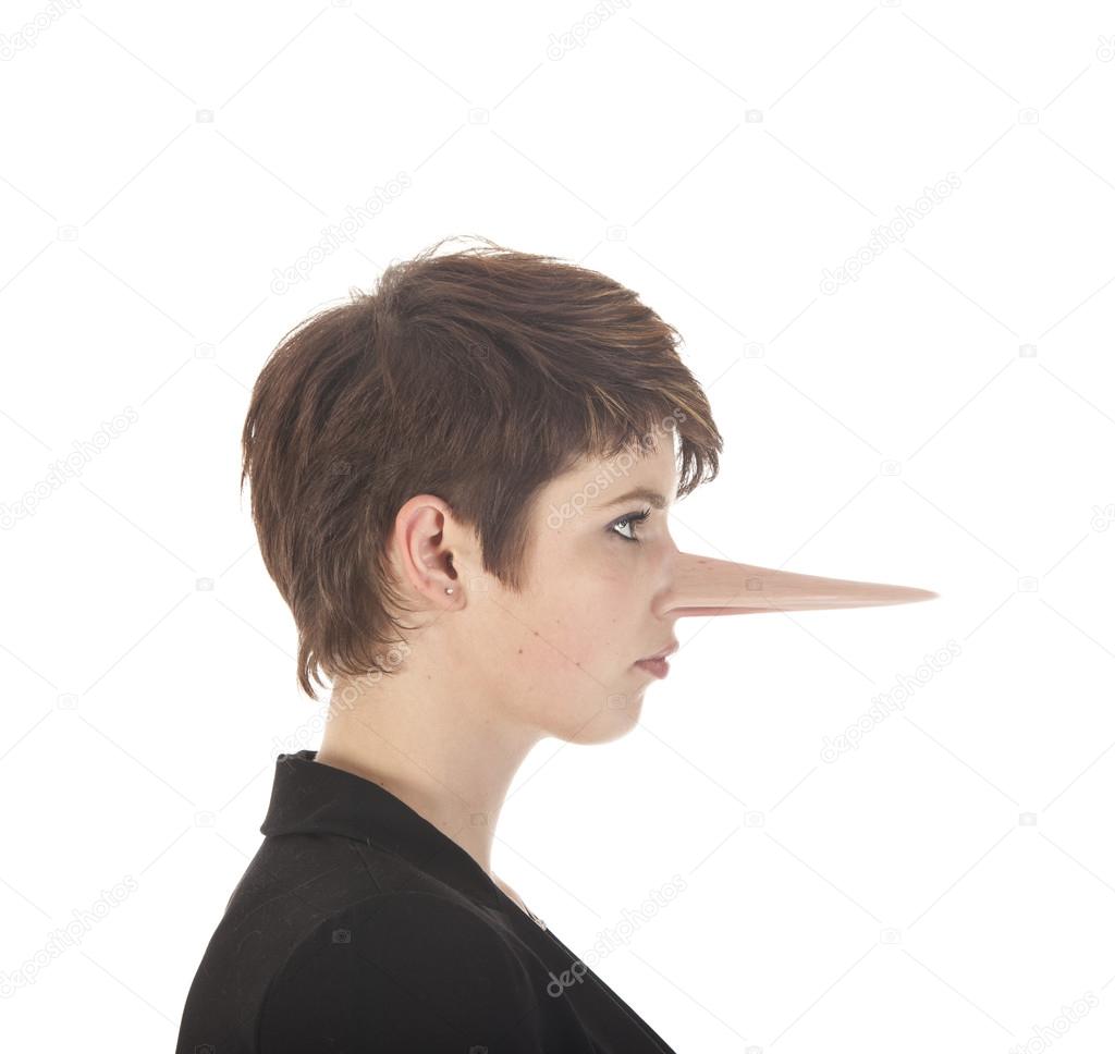 Young woman making a lie with long nose isolated on white background