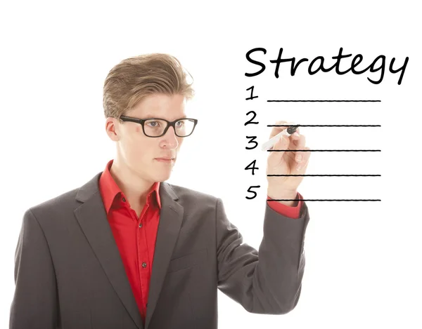 Young man writing strategy on white isolated background — Stock Photo, Image
