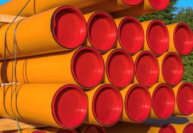 Pile of orange pvc protective pipes