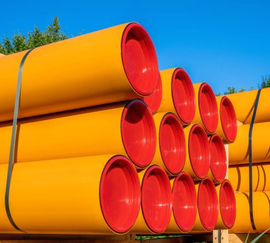 Pile of orange pvc protective pipes