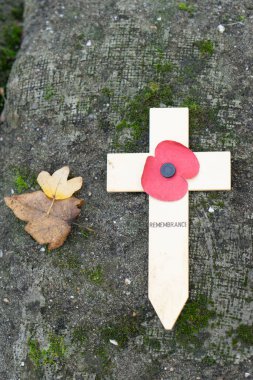 Lest we forget -  Remembrance poppy on a wooden cross symbol of the first World War WOI at old trenches near Ypres Belgium