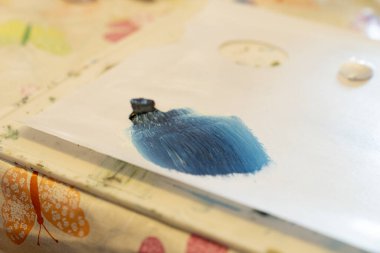 Grunge mixed  brush strokes of blue black and white paint on a palette