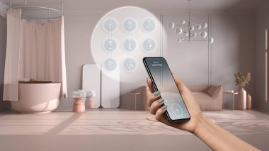 Telefon uygulamasında akıllı ev teknolojisi arayüzü, artırılmış gerçeklik, şeylerin interneti, bağlı nesnelerle bej banyonun iç tasarımı, kadın el kumandası cihazı