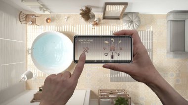 Dijital akıllı telefon tabletindeki uzaktan kumanda sistemi. Uygulama simgeleri olan aygıt. Arka planda küvet olan rahat bir banyo, mimari tasarım, üst görüş, plan, yukarıda.