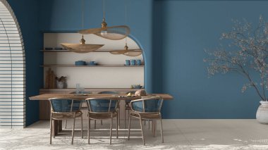 Modern yemek odası içerisi köy dairesi, krema ve mavi renkler, el işi ahşap masa, rattan sandalyeler, raflı beton duvarlar. Kopyalama alanı olan bir arkaplan tasarla