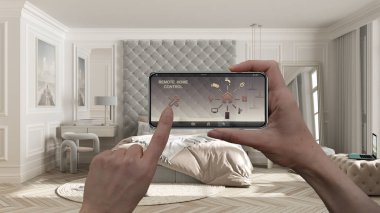 Akıllı bir telefondaki akıllı uzaktan kumanda sistemi. Uygulama simgeleri olan aygıt. Arka planda yatağı olan klasik pastel yatak odası, mimari tasarım.