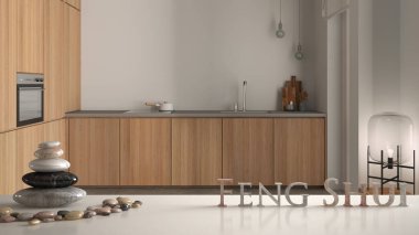Beyaz masa rafı, çakıl taşı dengesi ve 3 boyutlu harflerle beyaz ahşap mutfak, dekorlar ve aksesuarlar, minimalist zen iç dizayn konsepti üzerine feng shui kelimesi.