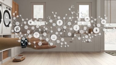 Woman wearing a smart watch, arm, wrist, geometric background with connected line and dots showing internet of things system, home automation concept over pet friendly laundry room