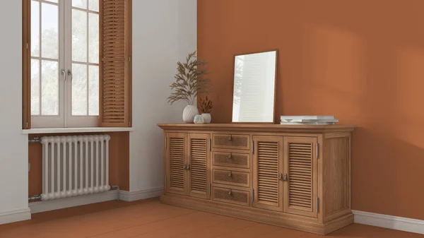 Retro living room with orange painted wooden floor and walls. Rattan chest of drawer with decor. Frame mock up. Window with shutters and radiator. Vintage interior design