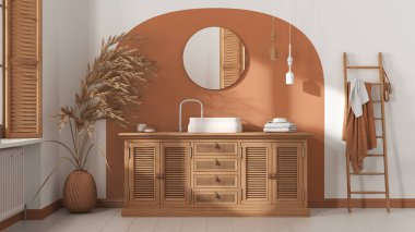 Beyaz ve turuncu tonlarda klasik banyo, rattan ahşap lavabo, çekmece sandığı, ayna, havlu askılığı ve dekor. Parke ve pencere. Modern iç tasarım