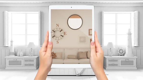 Hands holding tablet showing marine living room with sofa, total blank project background, augmented reality concept, application to simulate furniture and interior design products