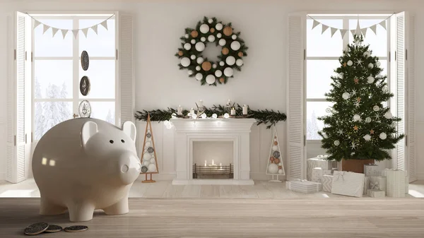Wooden table top or shelf with white piggy bank with coins, Christmas living room with tree, fireplace, expensive home interior design, renovation restructuring concept architecture