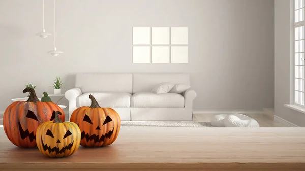 Halloween carved pumpkins on wooden table. Autumn decoration over interior design scene. Modern minimal living room with sofa and frame mockup