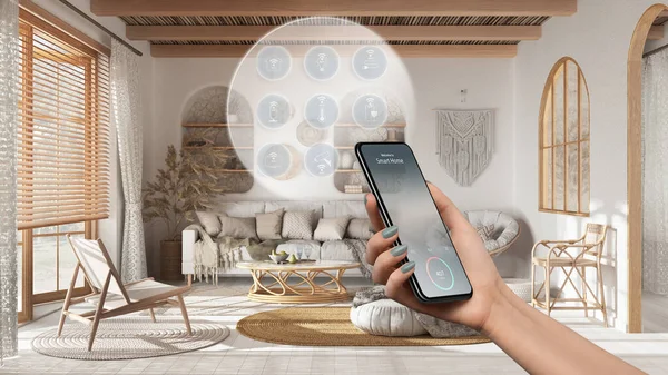 Smart home technology interface on phone app, augmented reality, internet of things, interior design of boho lounge with connected objects, woman hand holding remote control device