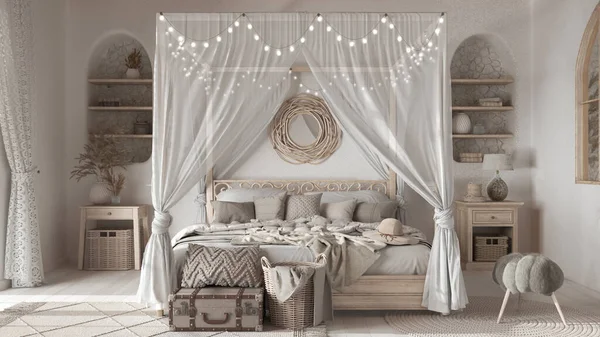 Bohemian bedroom with canopy bed in white and beige tones. Parquet and ethnic carpets. Rattan and bleached wooden furniture. Boho style interior design