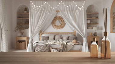 Ahşap masa ya da aromatik sopalarla bohem yatak odasının üzerinde bohem yatağı olan bir raf. Ülke mimarisi iç tasarım