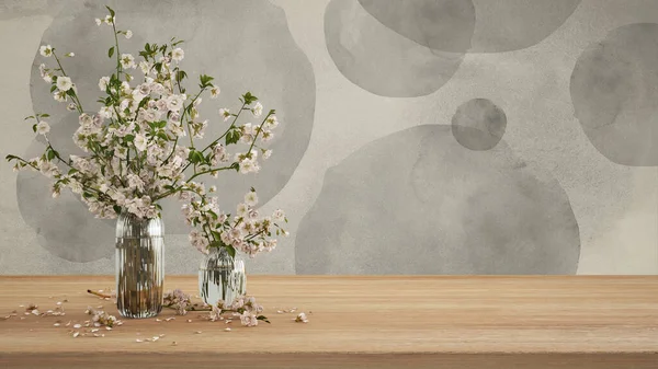Ahşap masa, masa ya da rafı kapat. Cam vazoda kiraz dalları çiçek açar. Duvarı gri tonlarda boyamış. Kopya alanı, şablon, model, bahar konsepti.